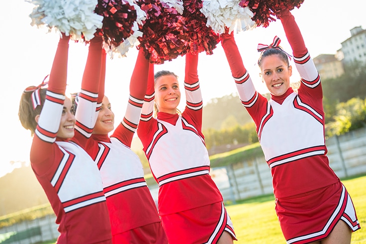 Group of Cheerleaders with Raised Pompom