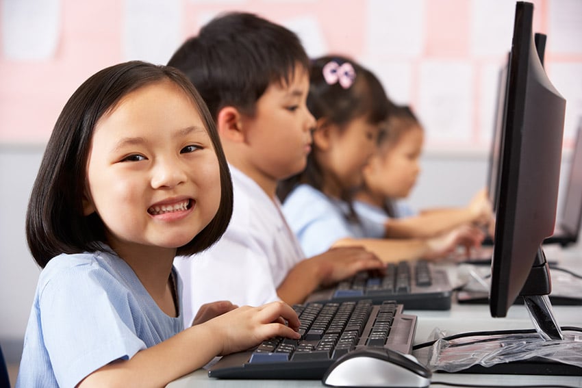 Pupil Using Keyboard During Computer Class In Chinese School