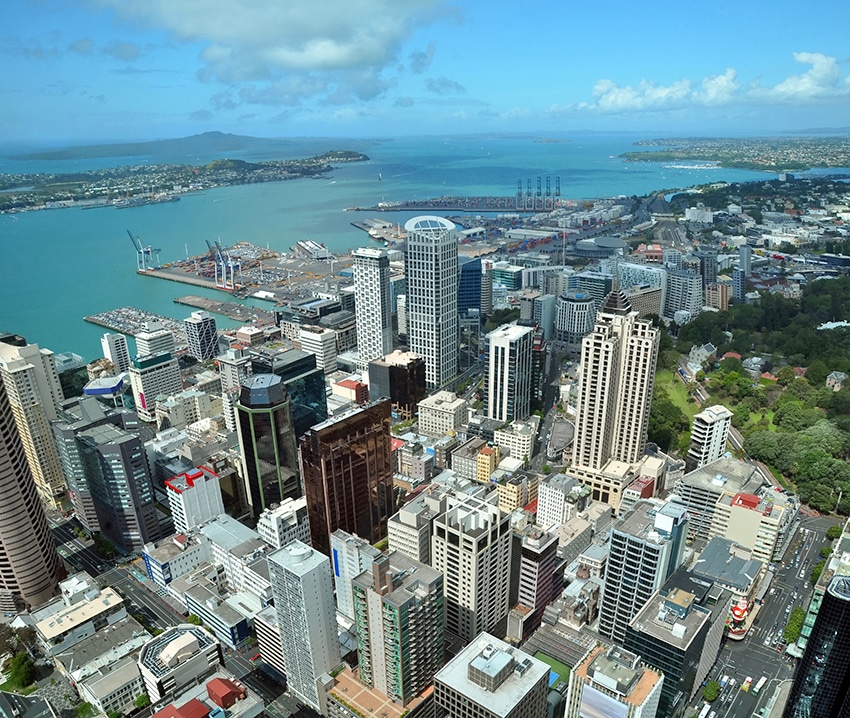 Auckland city & harbour vertical aerial panorama looking east to Rangitoto Island. In the foreground are the buildings of the Central business district. In the background are the Port of Auckland, container wharf, Devonport, Mechanics Bay, Auckland Domain, Tamaki Drive, Parnell, Mission Bay, Kohimarama and Saint Helliers Bay. In the distance are the Waitemata Harbour and Rangitoto Island.